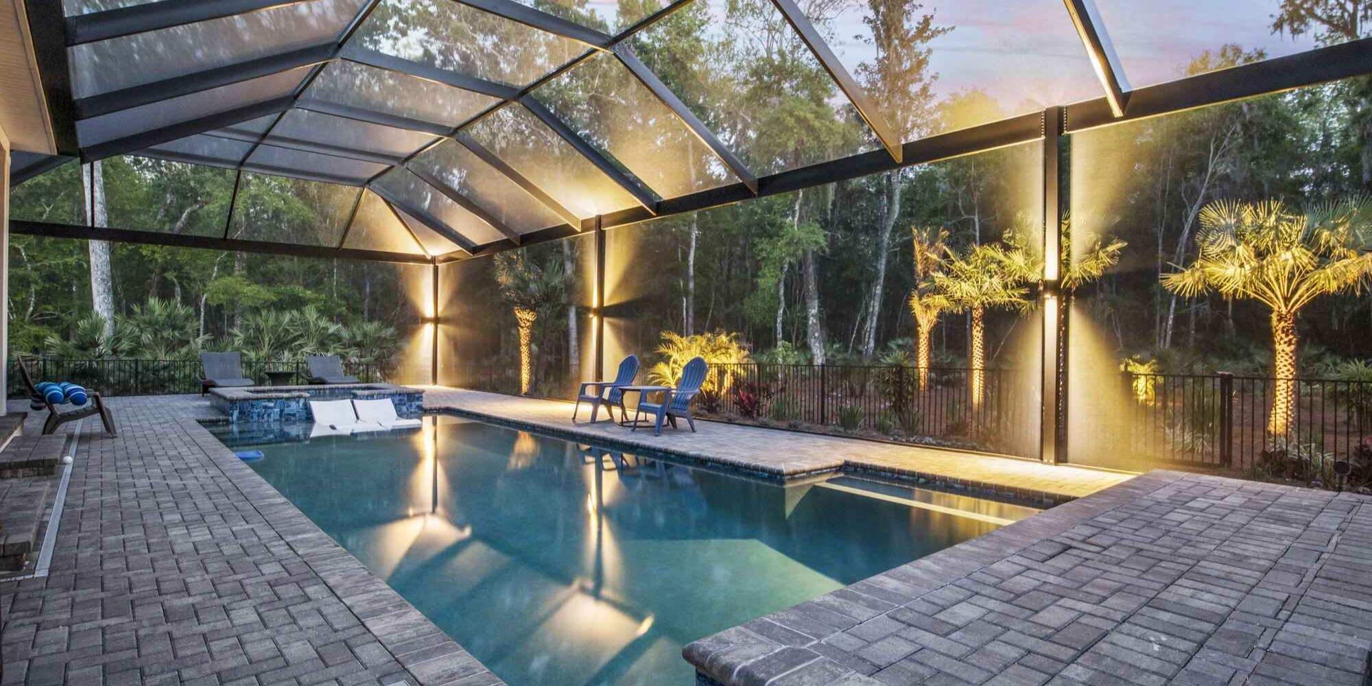 Evening pool vibes glow brighter with sleek enclosure lighting by Impact Enclosures in Jacksonville, FL