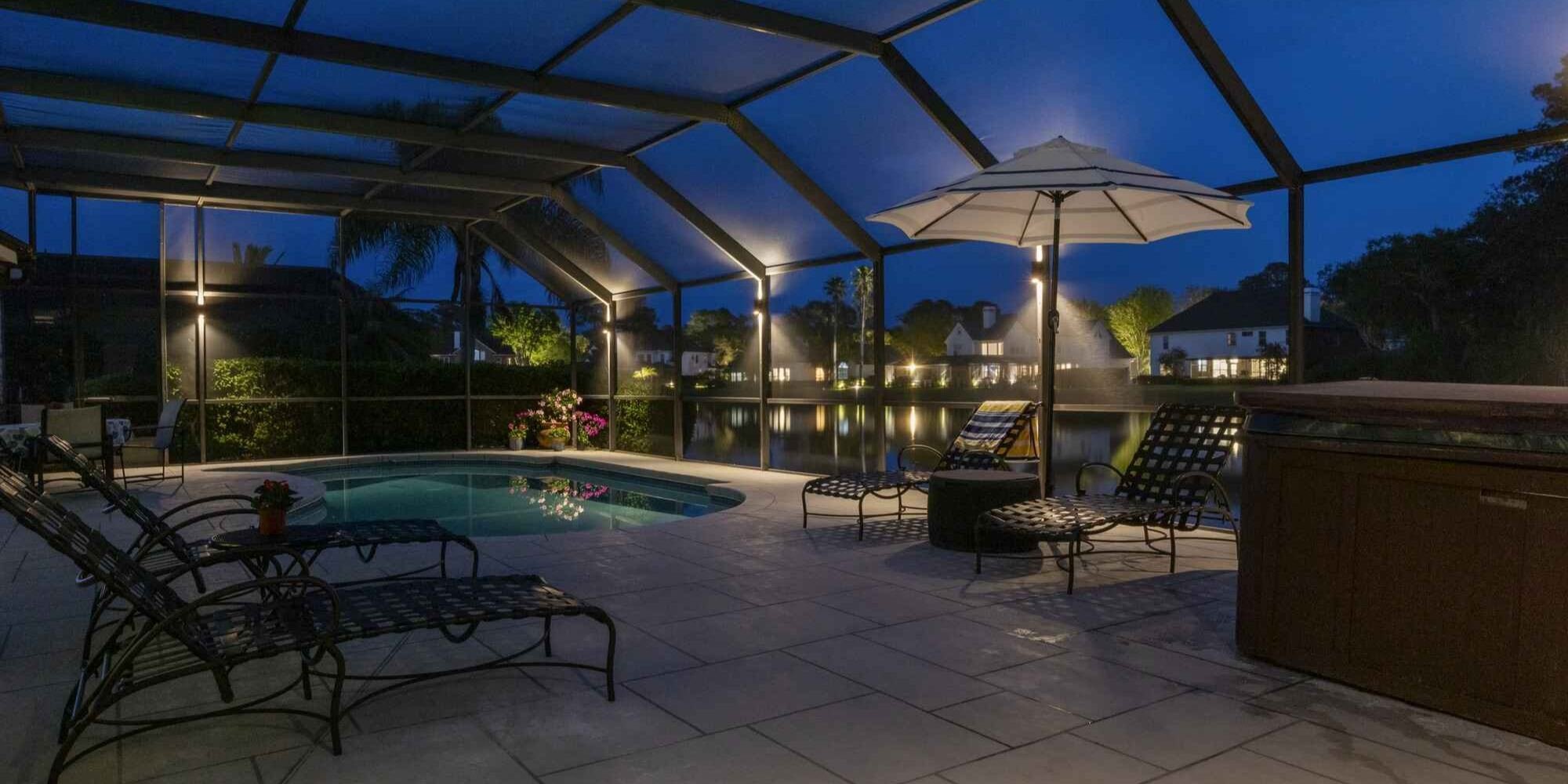 Outdoor pool enclosure with ambient lighting by Impact Enclosures in Jacksonville, FL