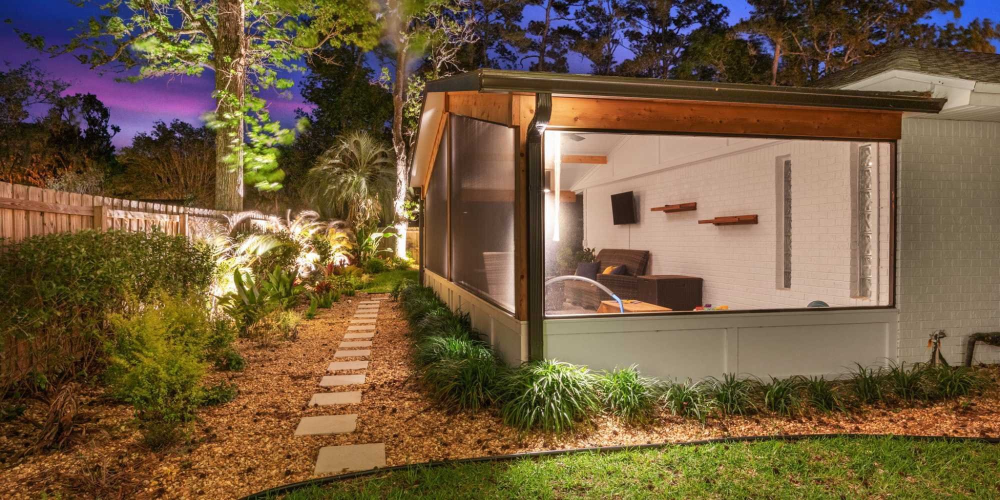 Screen enclosure with modern landscape lighting by Impact Enclosures in Jacksonville, FL