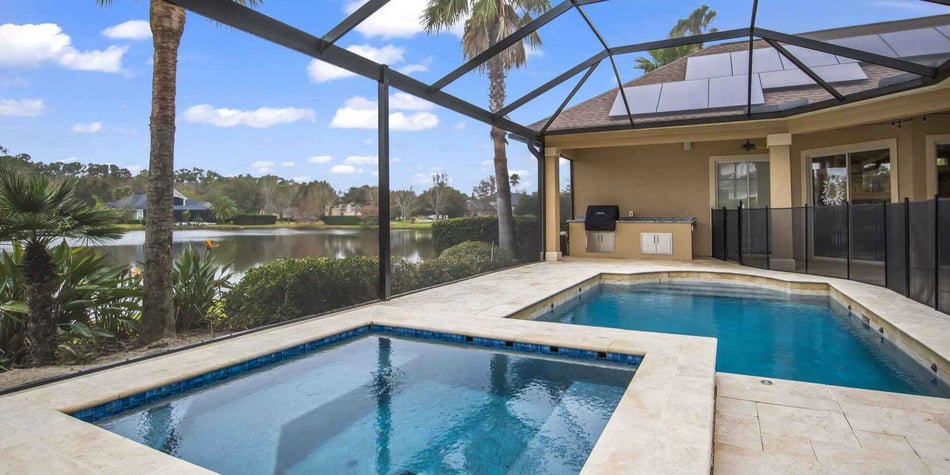 Image of a large screen enclosure by Impact Enclosures built over a patio and pool in Jacksonville, FL