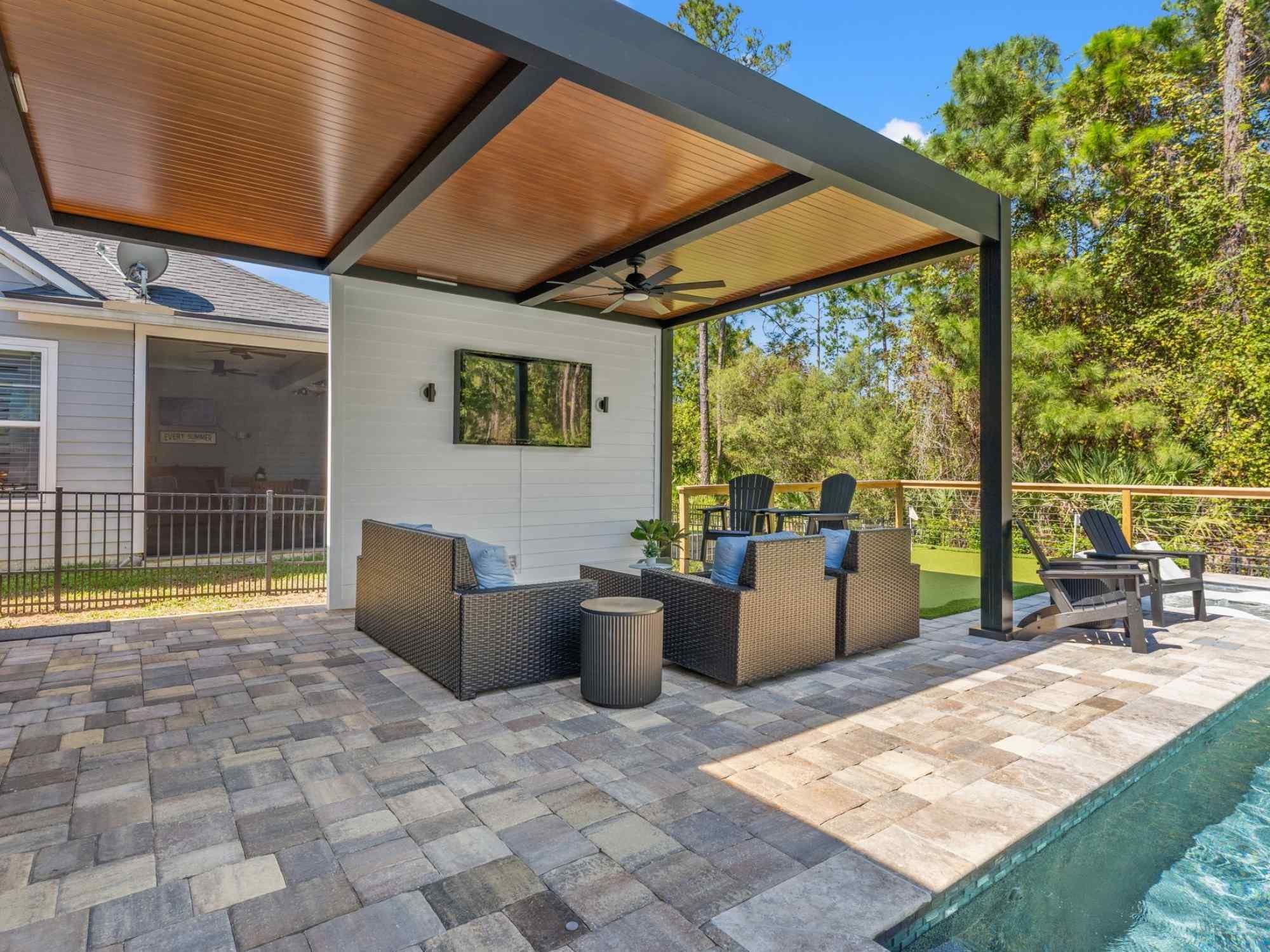 Image of outdoor living space with faux wood ceiling pergola and poolside patio in Jacksonville, FL by Impact Enclosures Image of outdoor living space with faux wood ceiling pergola and poolside patio in Jacksonville, FL by Impact Enclosures
