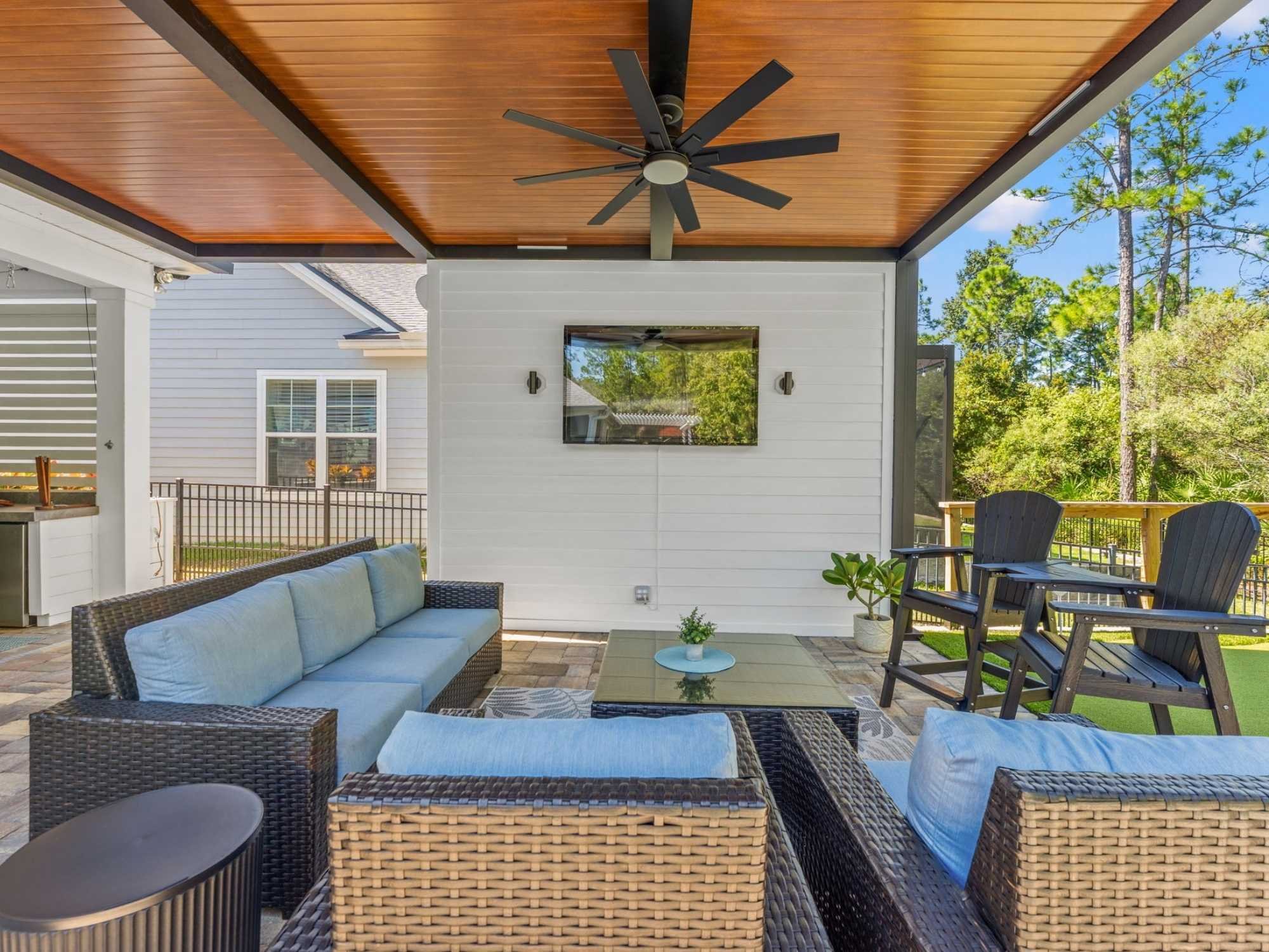 Image of patio with Hardie slat privacy wall and mounted TV feature in Jacksonville, FL by Impact Enclosures