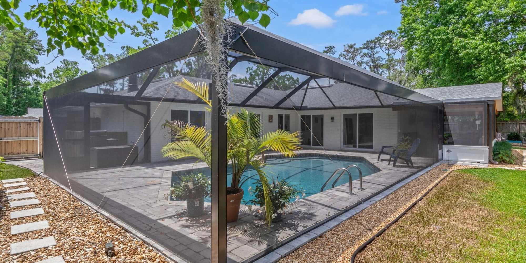 Pool enclosed with a screen per Florida Law to have a compliant safety barrier - Impact Enclosures