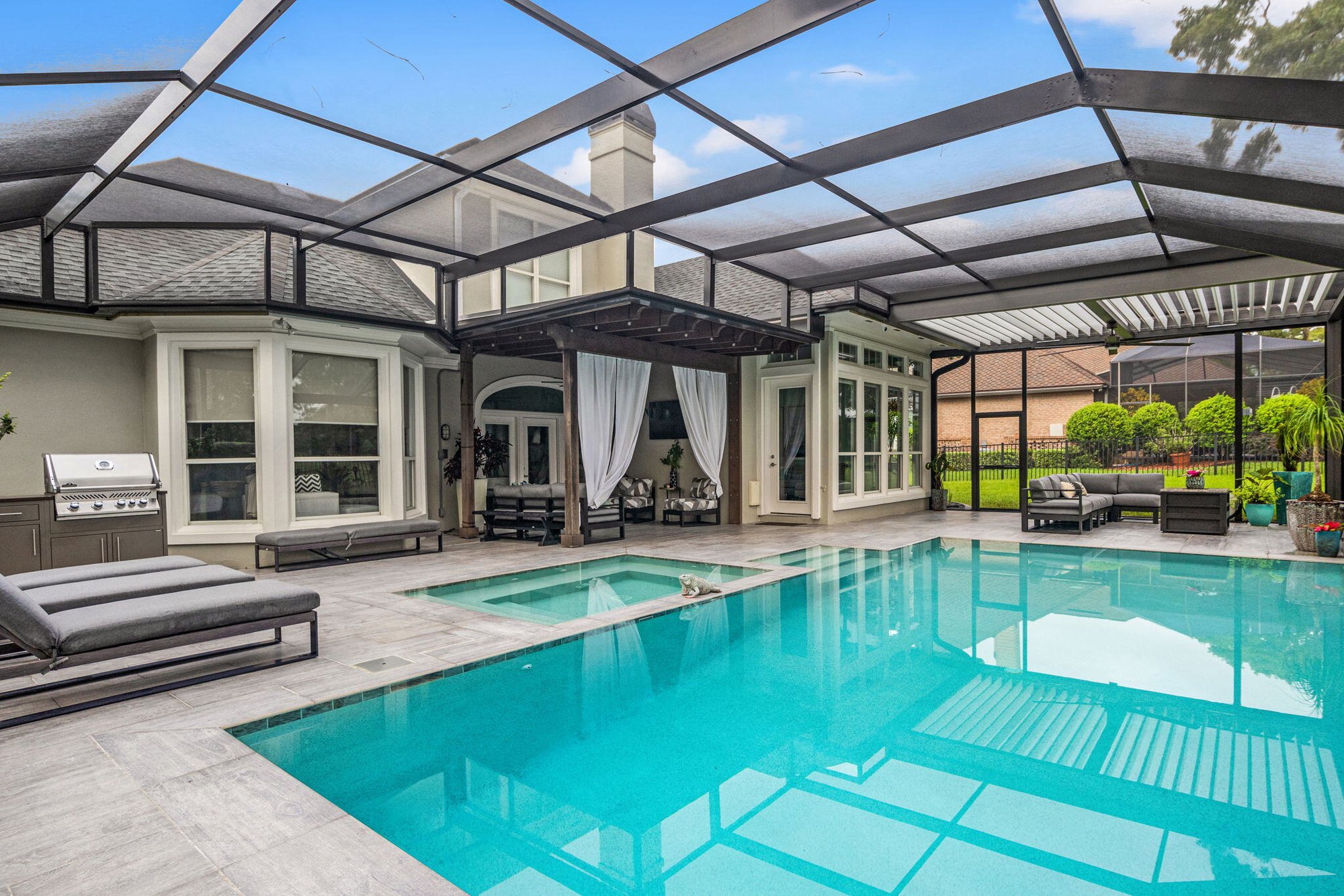 screen enclosure and motorized pergola and landscaping