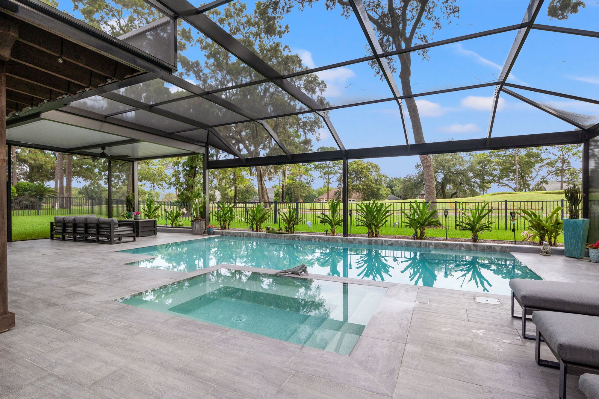 screened enclosure with landscaping and motorized pergola