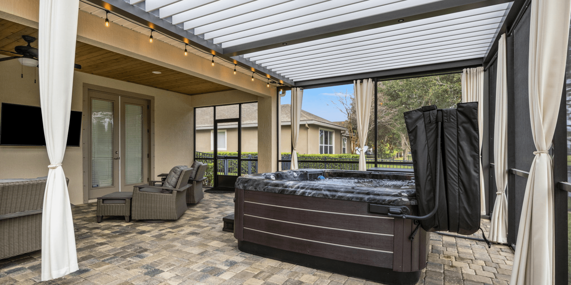 Hot Tub in a Screen Enclosure Under a Motorized Pergola