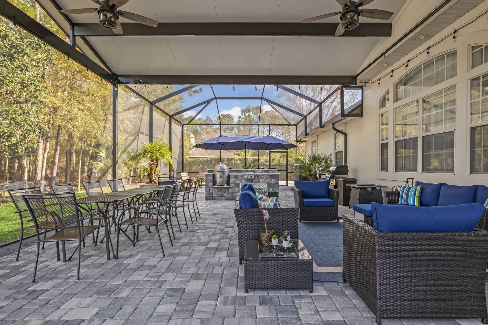 Motorized Screen Room with Beautiful Stone Patio and Outdoor Kitchen