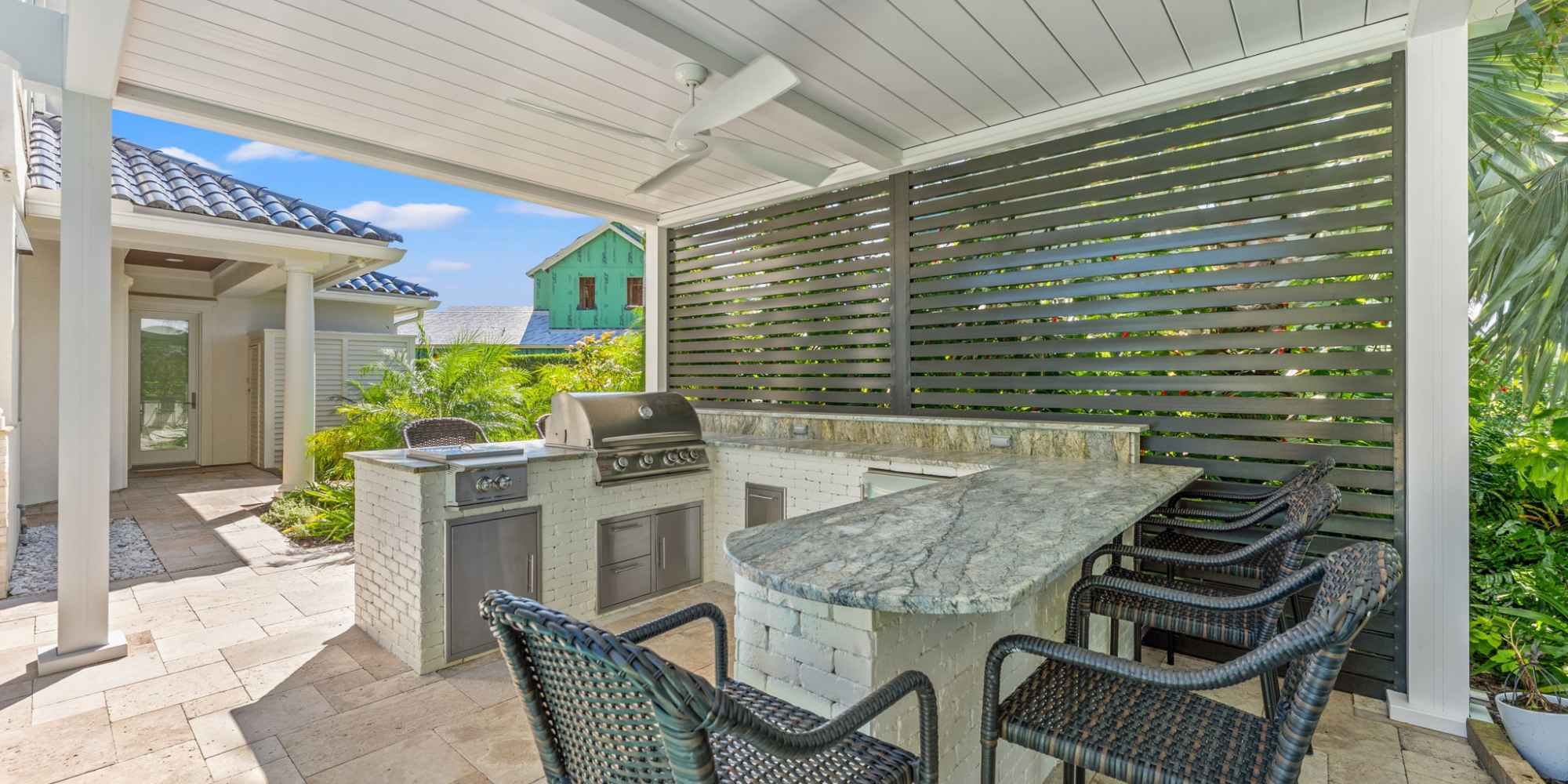 Image of a motorized screen, pergola, and outdoor kitchen on Ponte Vedra Beach by Impact Enclosures Image of a motorized screen, pergola, and outdoor kitchen on Ponte Vedra Beach by Impact Enclosures