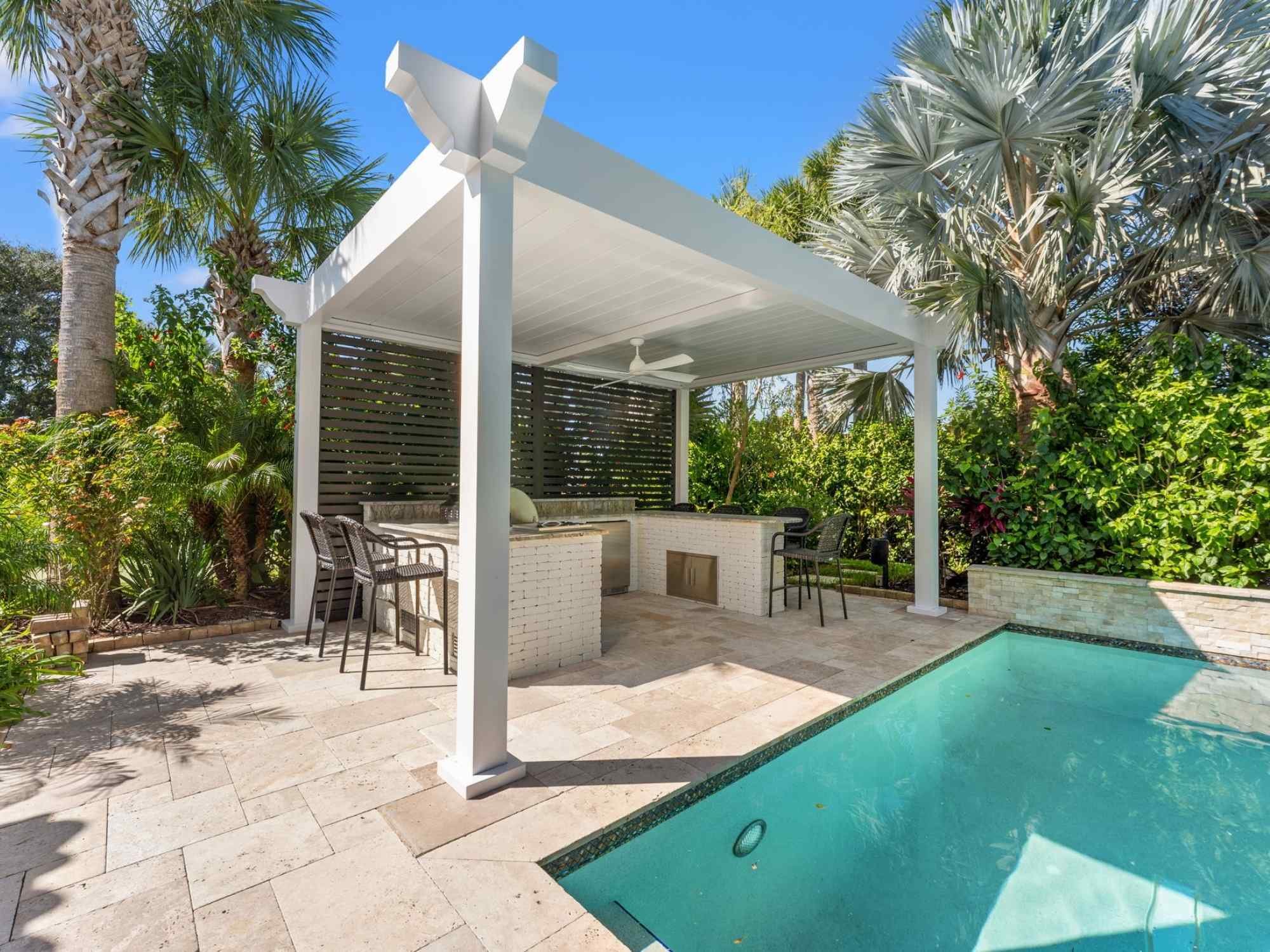 Image of a pergola with motorized screen and outdoor kitchen by Impact Enclosures in Ponte Vedra Beach, FL