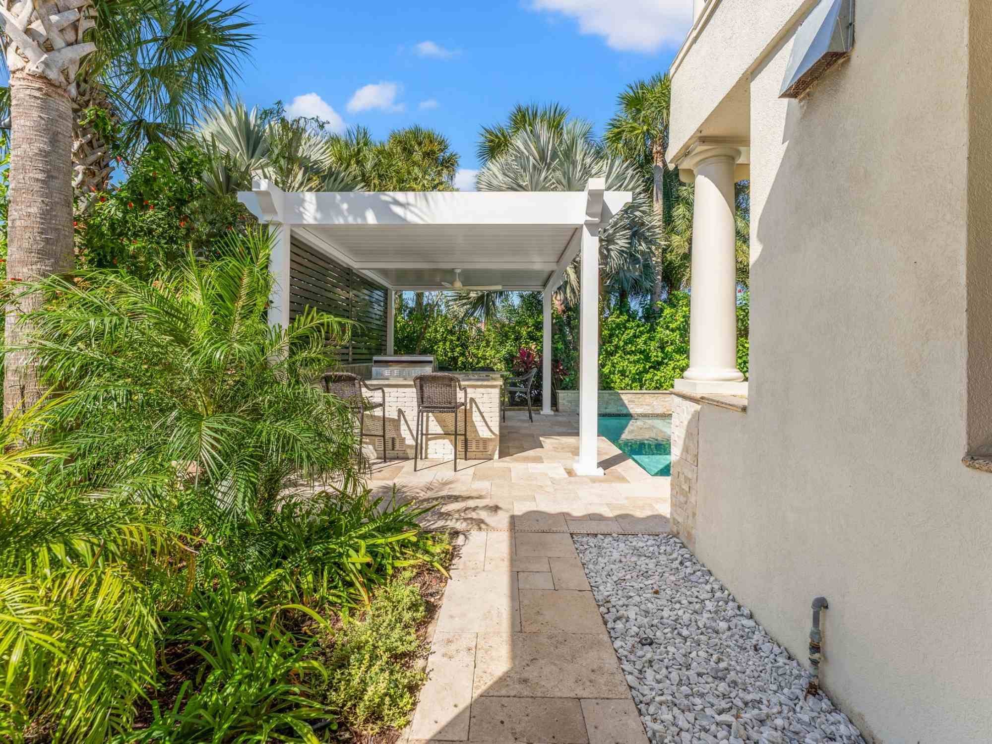 Image of a pergola with outdoor kitchen and stone patio by Impact Enclosures in Ponte Vedra Beach, FL Image of a pergola with outdoor kitchen and stone patio by Impact Enclosures in Ponte Vedra Beach, FL