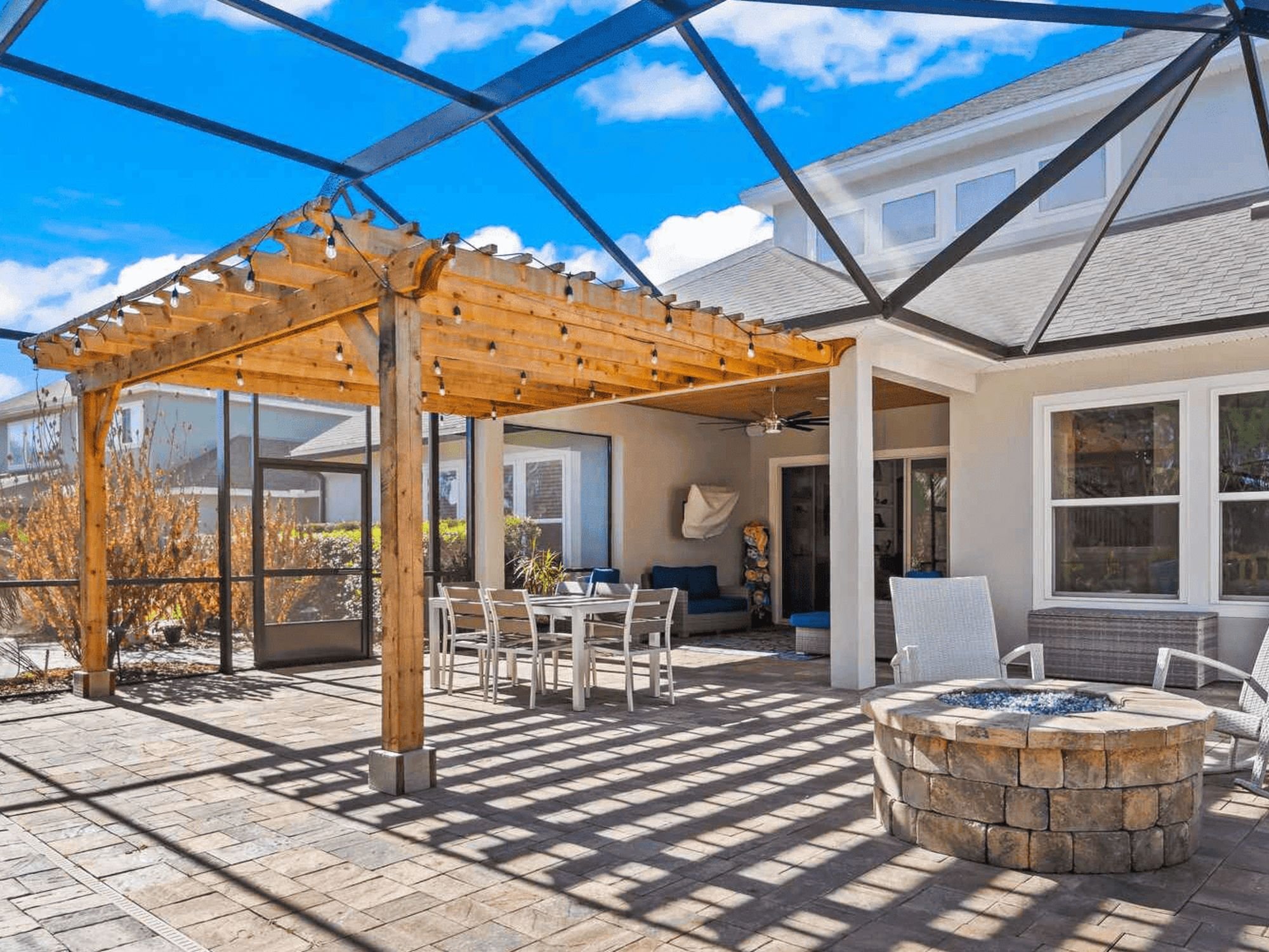 Interior of a patio screen room with a wooden pergola inside by Impact Enclosures in Jacksonville, FL Interior of a patio screen room with a wooden pergola inside by Impact Enclosures in Jacksonville, FL