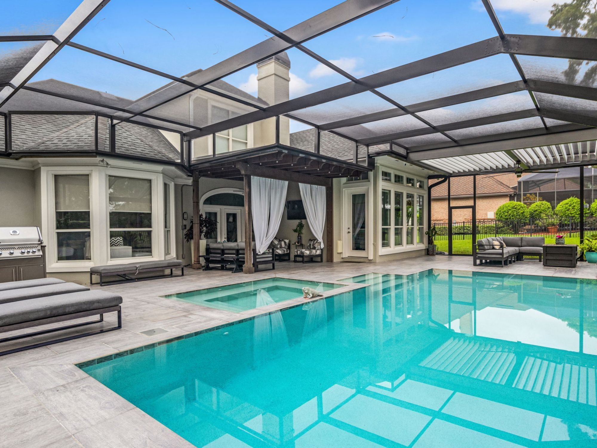 Interior of a pool screen enclosure with a screen roof by Impact Enclosures in Jacksonville, FL