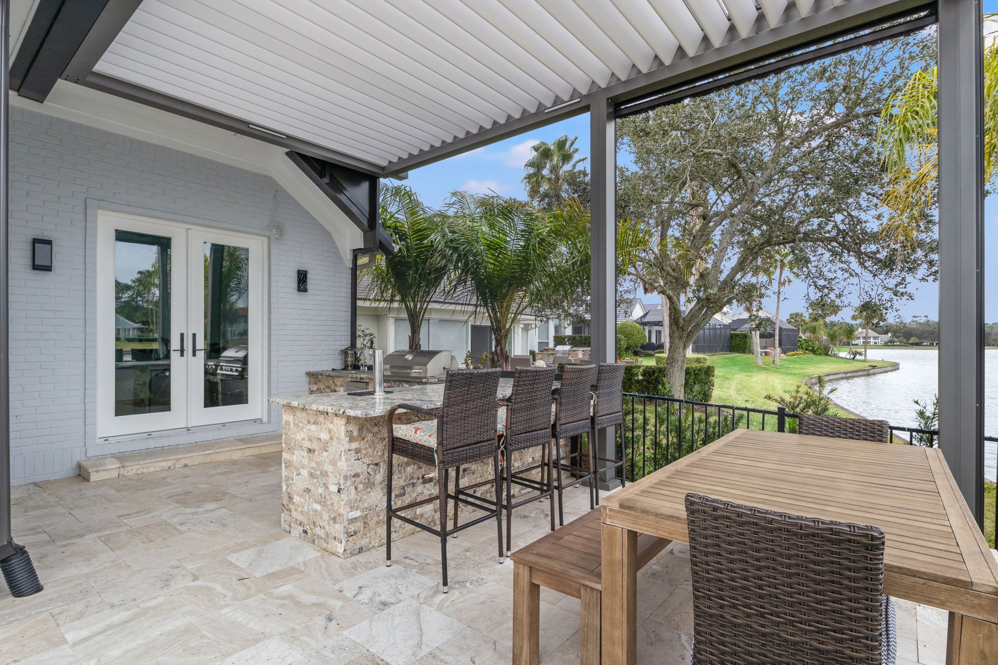 French Doors to Summer Kitchen in Jacksonville with Pergola and Motorized Screens