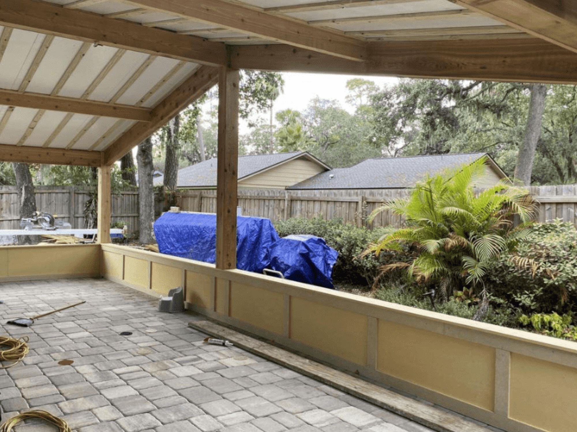 Before Image of Covered Patio with Wall Being Built