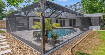 Image of a screen enclosure by Impact Enclosures around a patio with a pool in Jacksonville, FL
