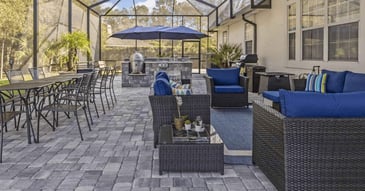 Image of a screened enclosure with patio pavers and outdoor kitchen by Impact Enclosures in Jacksonville, FL
