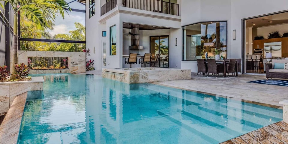 Image of an outdoor enclosure by Impact Enclosures and patio with a pool in Jacksonville, FL