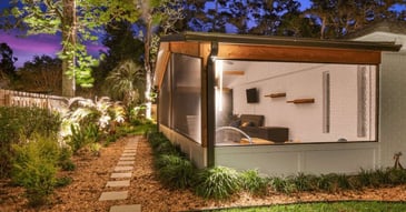 Image of an outdoor screen enclosure with landscape lighting in Jacksonville, FL by Impact Enclosures