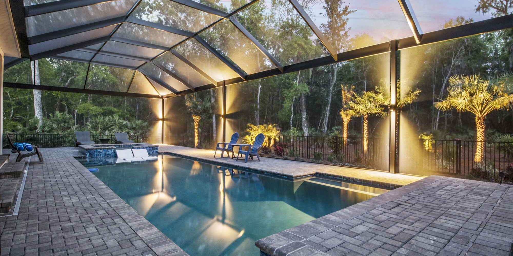 Evening pool vibes glow brighter with sleek enclosure lighting by Impact Enclosures in Jacksonville, FL