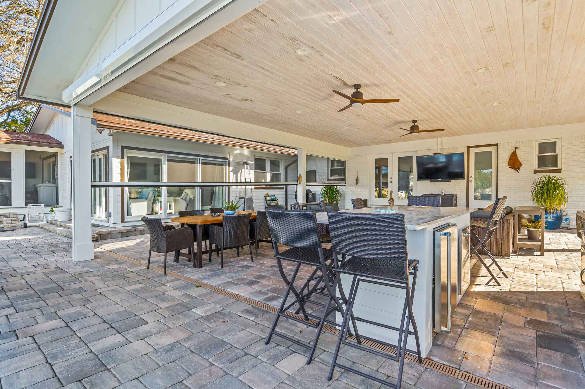 Motorized Screen Enclosure with Tongue and Groove Ceiling and Outdoor Kitchen