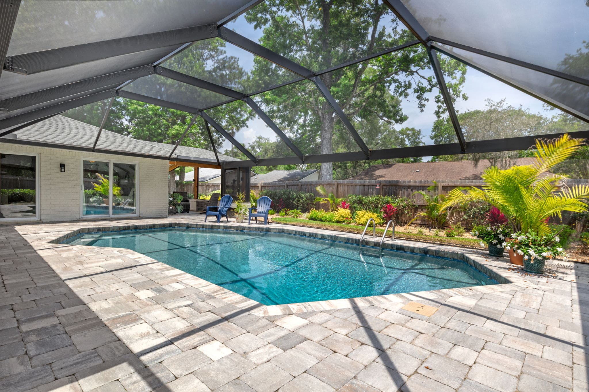 New Pool Enclosure with Screen on Sides and Top Over Stone Patio